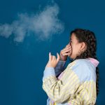 Passive smoking concept.Teen girl pinch her nose because toxic fumes from car,bad smell.