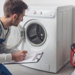 Professional technician checking a washing machine