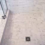 Skilled tradework installation of ceramic tiles in mosaic style in modern shower, home improvement
